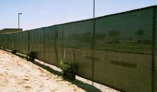 Woven privacy fence panels installed on tennis court fence