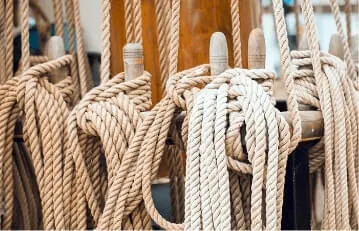 Coiled ropes secured around wooden pegs